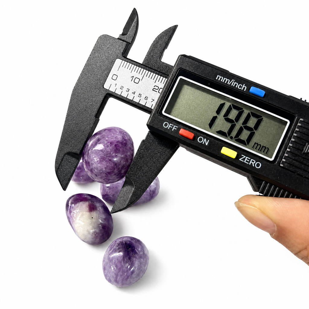 Hand-selected Phosphosiderite tumbled stones being measured with a digital caliper, showing size approximately 18mm to 22mm, premium quality healing crystals from VoraZen.