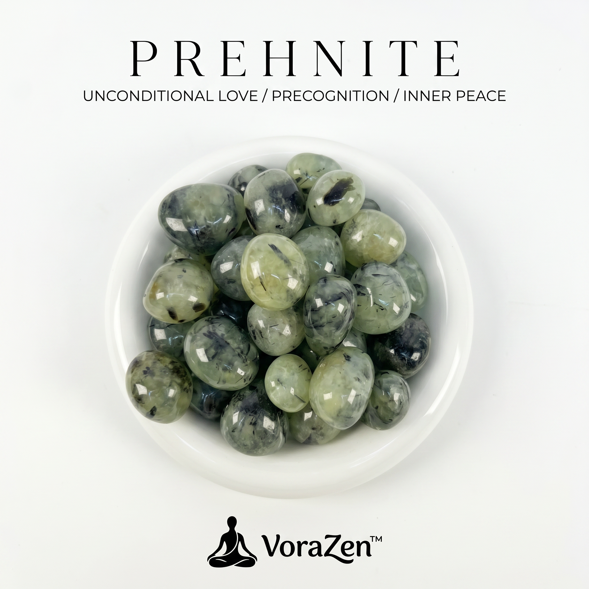 VoraZen™ Natural Prehnite Tumbled Stones in a white porcelain bowl. These translucent pale green crystals feature unique dark inclusions of Epidote, known as the "Stone of Prophecy and Unconditional Love." High-quality polished finish, perfect for meditation and heart chakra healing.